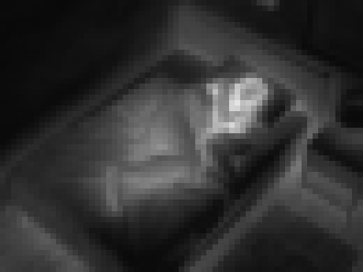 Privacy-masked camera view of the bedroom — strong masking, the person unidentifiable.